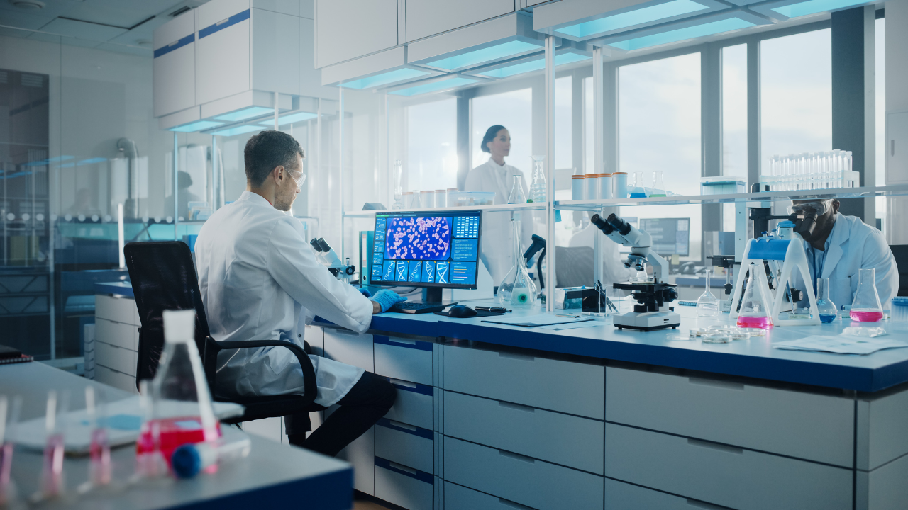 Medical Science Laboratory with Diverse Multi-Ethnic Team of Biotechnology Scientists Developing Drugs, Microbiologist Working on Computer with Display Showing Gene Editing Interface. Image Credit: Adobe Stock Images/Gorodenkoff