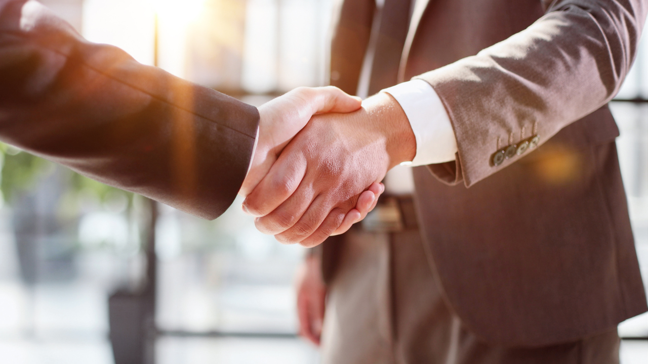 Business shaking hands, finishing up meeting. Successful businessmen handshaking after good deal. Image Credit: Adobe Stock Images/Katsiaryna