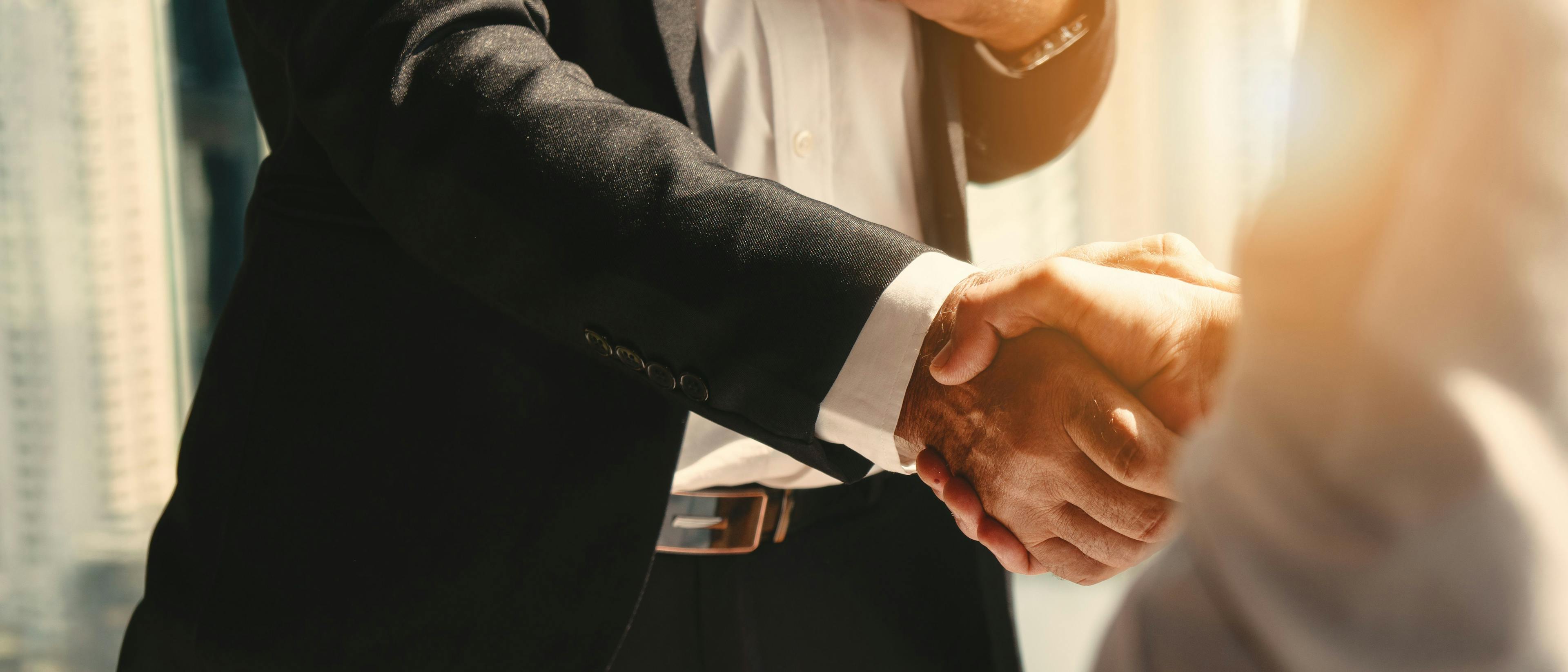 businessman handshake for teamwork of business merger and acquisition. Image Credit: Adobe Stock Images/Mongkolchon