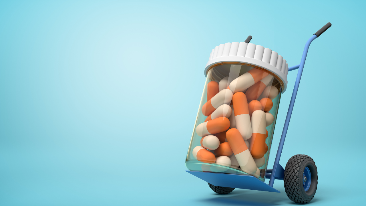 3d rendering of a plastic jar with medical pills on a hand truck on blue background. Image Credit: Adobe Stock Images/gearstd