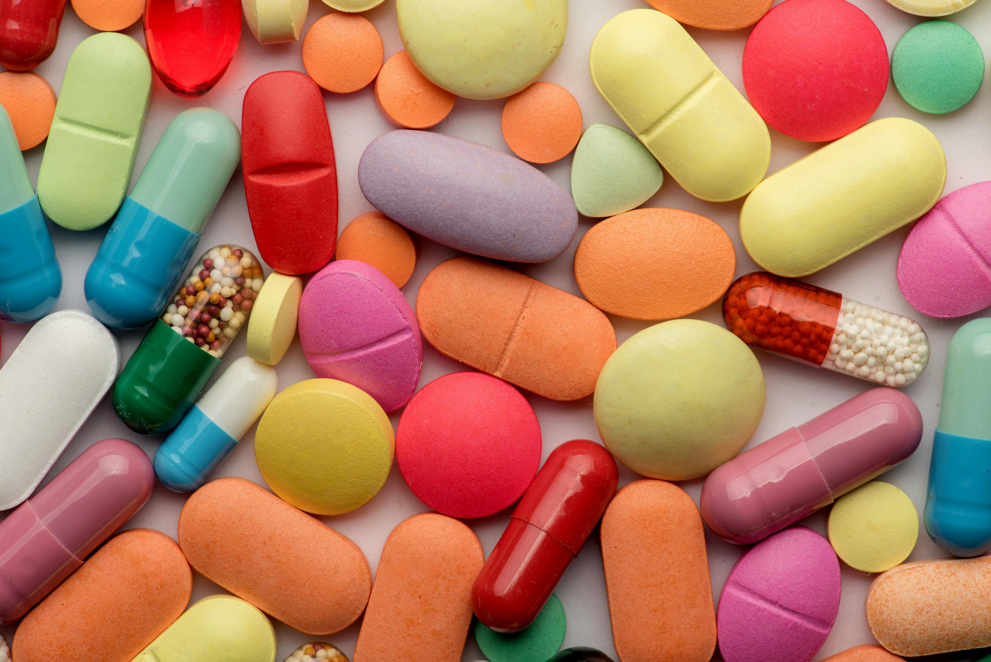 Multicolored tablets on white background. Image Credit: Adobe Stock Images/grthirteen