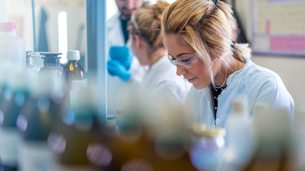Beautiful young woman scientist in laboratory working. Young female scientist doing some research. Image Credit: Adobe Stock Images/Vladimir Borovic