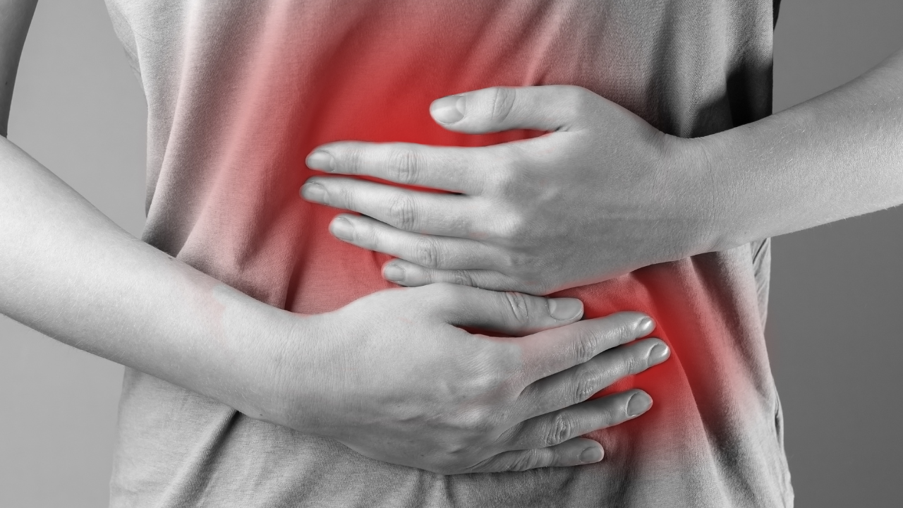 Stomach ache concept. Hands holding belly abdomen suffering from indigestion, gastrointestinal disease, pain, inflammation. Image Credit: Adobe Stock Images/valiantsin