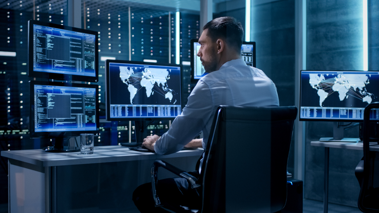 Technical Controller Working at His Workstation with Multiple Displays. Displays Show Various Technical Information. He's Alone in System Control Center. Image Credit: Adobe Stock Images/Gorodenkoff